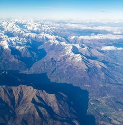 Aerial view of snowcapped mountains against sky