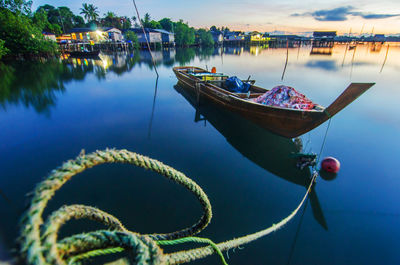 Boats moored on shore against sky