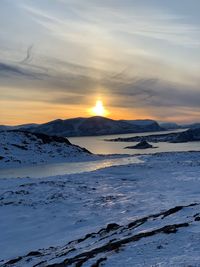 Scenic view of snowcapped mountains against sky during sunset