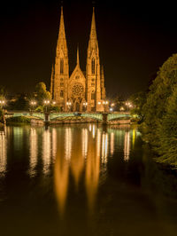 Reflection of church in water at night