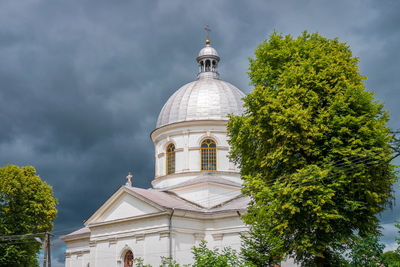 Former brick greek catholic church in werchrata, erected in 1910. the dramatic sky in the background