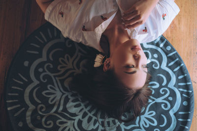High angle portrait of woman lying on floor