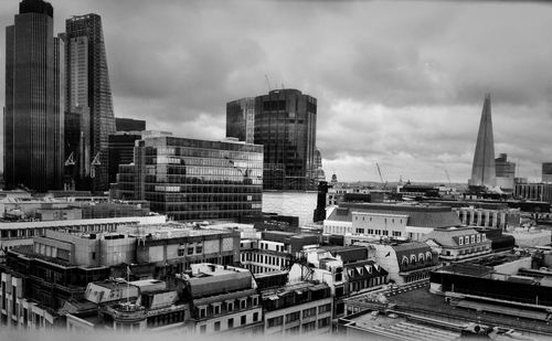 View of cityscape against cloudy sky