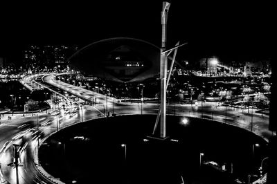 Illuminated road in city at night