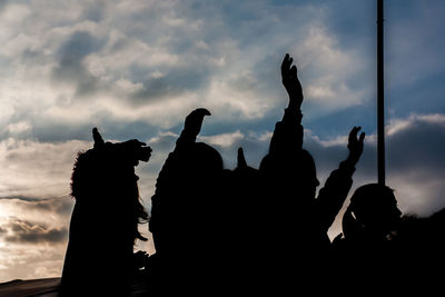 Low angle view of silhouette statue against sky during sunset