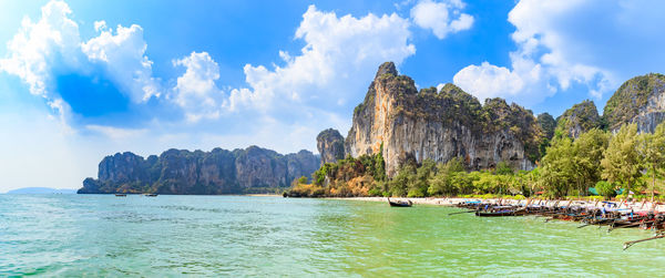 Panoramic view of sea and mountains against sky