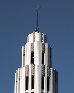 Low angle view of skyscraper against clear blue sky