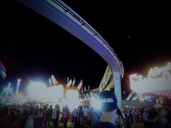 Panoramic view of illuminated crowd at night