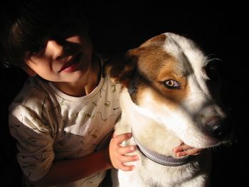Close-up portrait of child with dog
