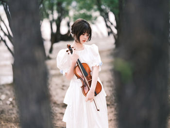 Portrait of young woman standing outdoors