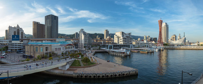 Buildings by river in city