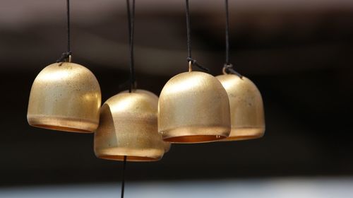 Close-up of bells hanging outdoors