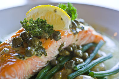 Close up of salmon with capers and lemon