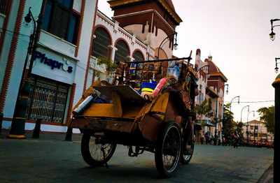 Bicycles on street against buildings in city