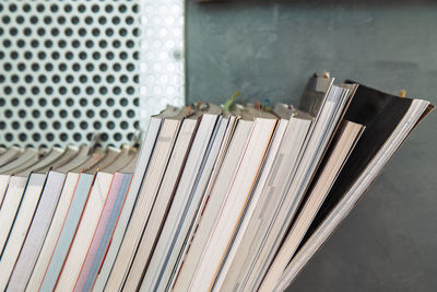 Close-up of books on shelf against wall