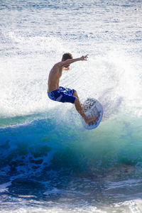 Surfer surfing in sea