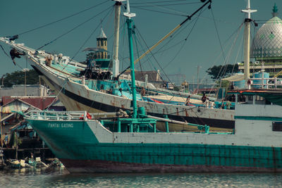 Two phinisi ships are docked at the port of paotere, makassar, indonesia.