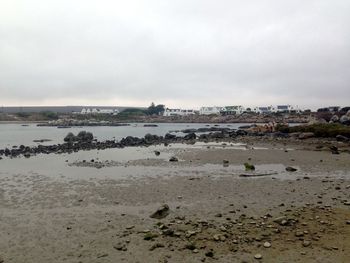 View of beach against cloudy sky