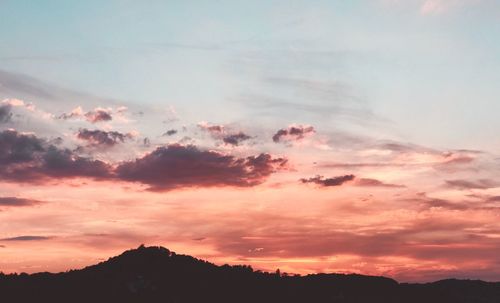 Low angle view of silhouette mountains against sky during sunset