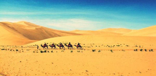 Scenic view of desert against clear blue sky