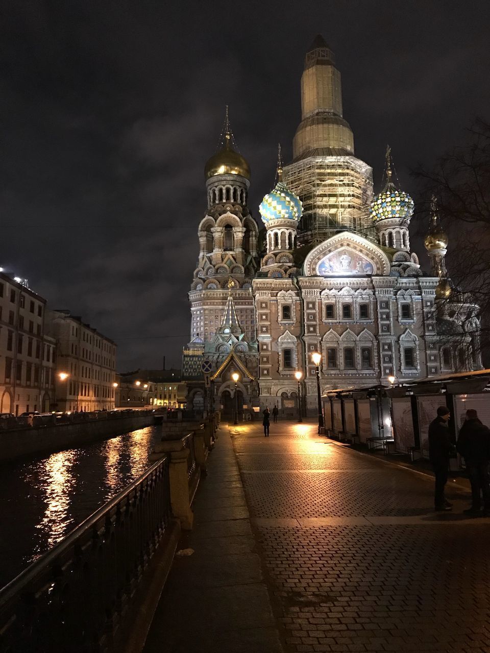 ILLUMINATED CATHEDRAL IN CITY AT NIGHT