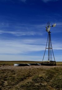 Windmill with three stock tanks