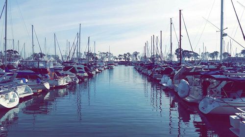 Boats moored in calm sea against sky