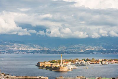 Scenic view of sea and buildings against sky