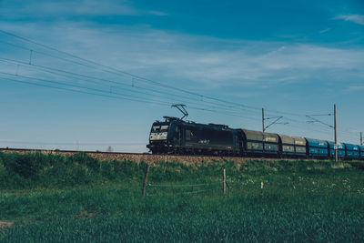 Train on railroad track against sky