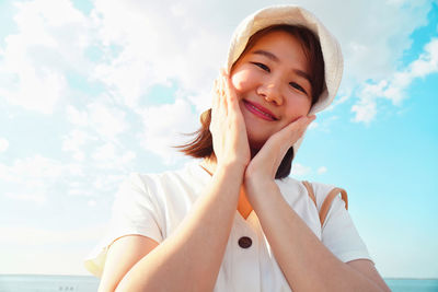 Portrait of smiling girl against sky