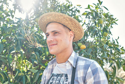 Portrait of man wearing hat against trees