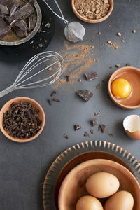 Mix of baking dessert ingredients on dark background, culinary flat lay