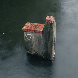 High angle view of wooden post in lake