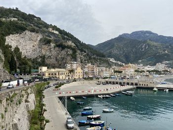 High angle view of townscape by sea against mountain