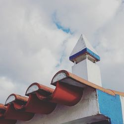 Low angle view of chimney against cloudy sky