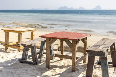 Deck chairs on table at beach