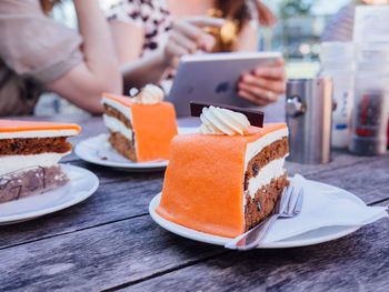 High angle view of hand holding ice cream in plate on table