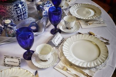 Close-up of plates and glasses on dining table