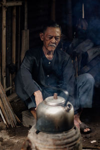 Portrait of senior man working at workshop