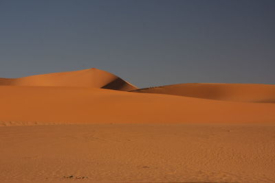 Scenic view of desert against clear sky