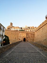 View of footpath against clear sky