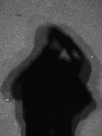 Shadow of woman on street in city