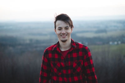 Portrait of smiling young man standing outdoors