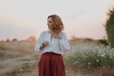 Young woman standing on field