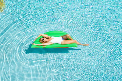 High angle view of lying down in swimming pool