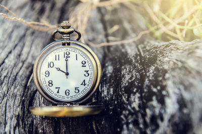 Close-up of clock on wooden table