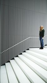 Rear view of man standing on staircase