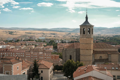 Buildings in town against sky