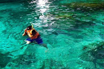 High angle view of woman swimming in sea