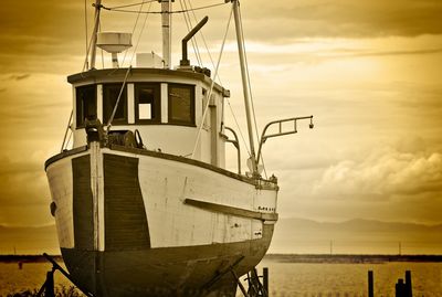 Ship moored on sea against sky